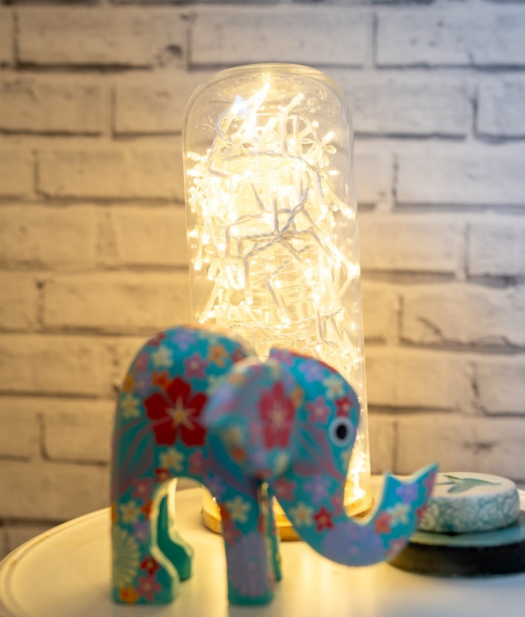 Decorative elephant figurine holding glowing string lights