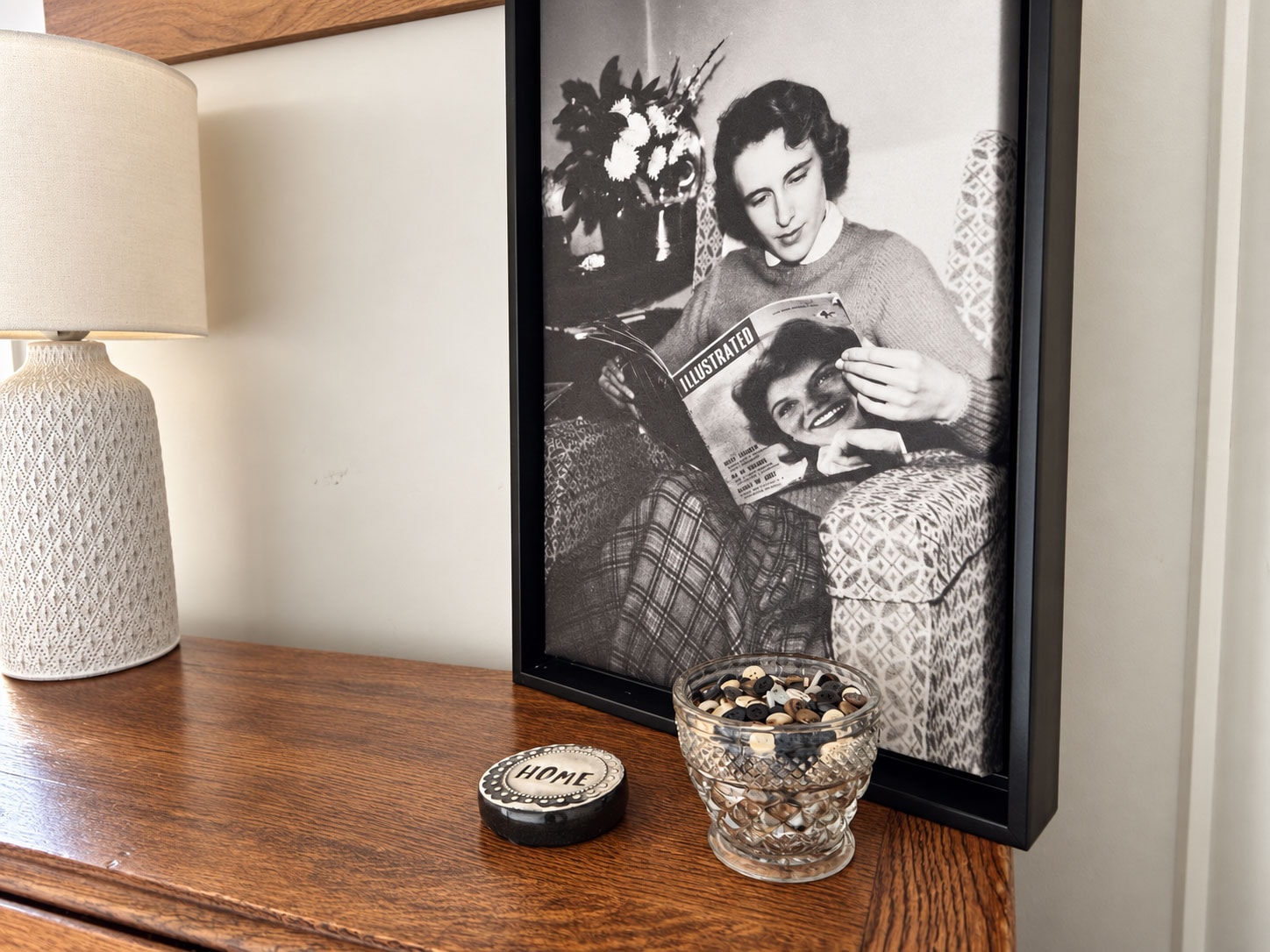 Framed black and white photograph on a styled shelf